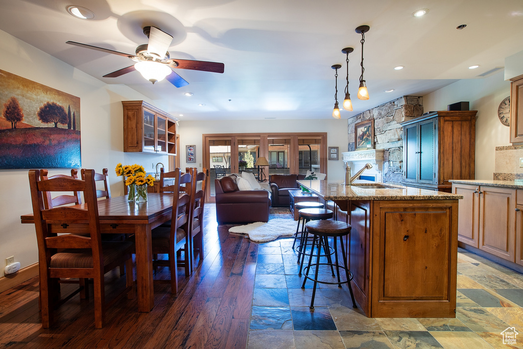 Interior space with ceiling fan, hardwood / wood-style flooring, and sink