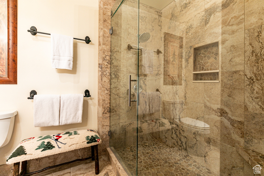 Bathroom featuring an enclosed shower and toilet