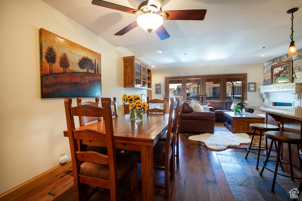 Dining space featuring dark hardwood / wood-style flooring and ceiling fan