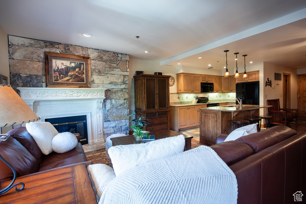 Living room featuring a stone fireplace