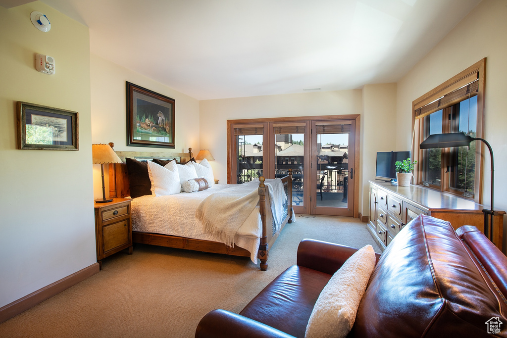 Carpeted bedroom featuring access to exterior