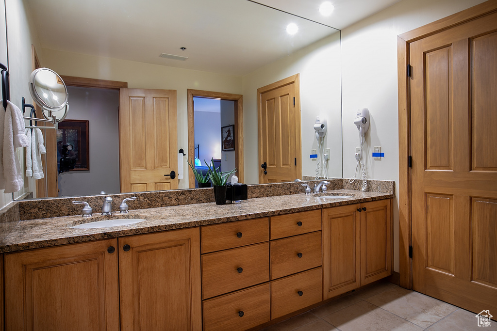 Bathroom featuring tile patterned flooring and vanity