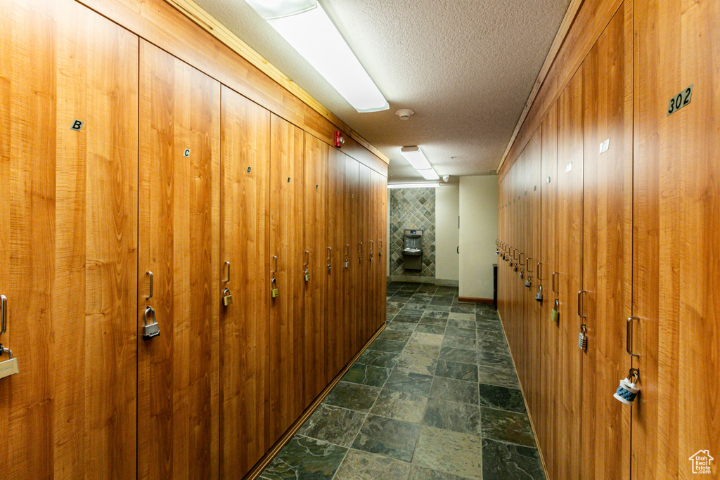 Hall featuring a textured ceiling