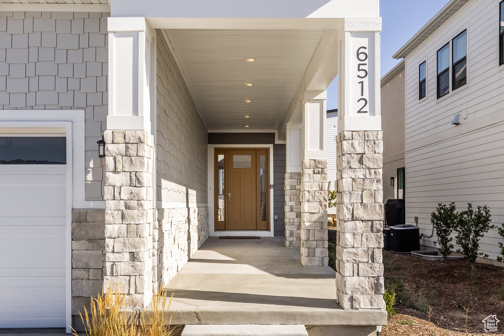 View of exterior entry featuring central AC unit