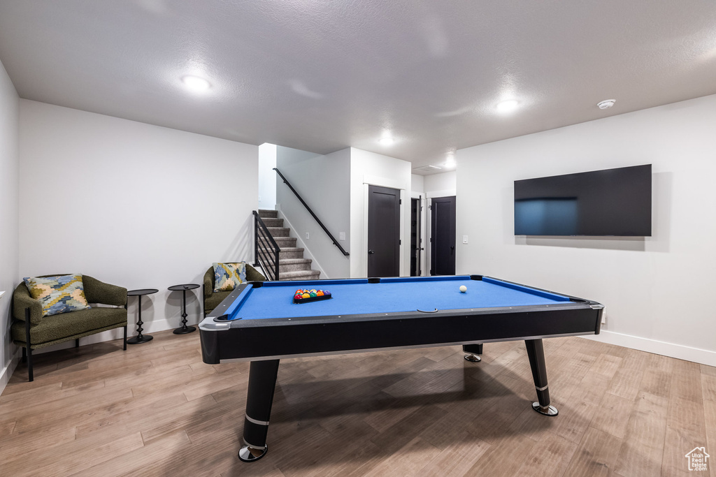 Playroom with pool table and light hardwood / wood-style floors