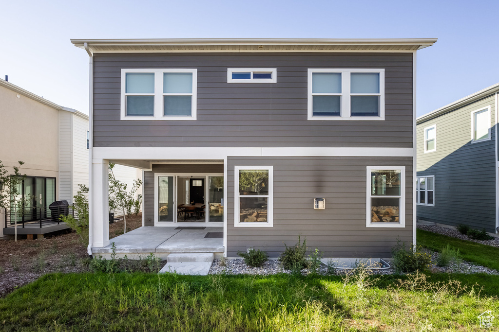 Rear view of property featuring a patio area