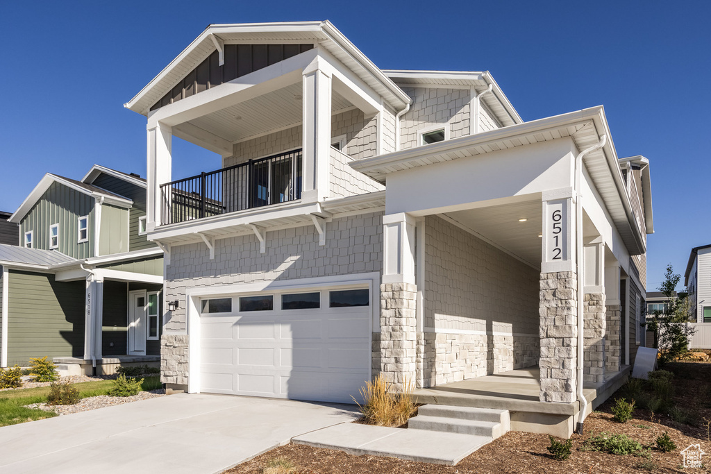 View of front facade with a balcony and a garage