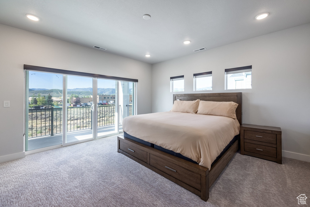 Bedroom with light colored carpet and access to exterior