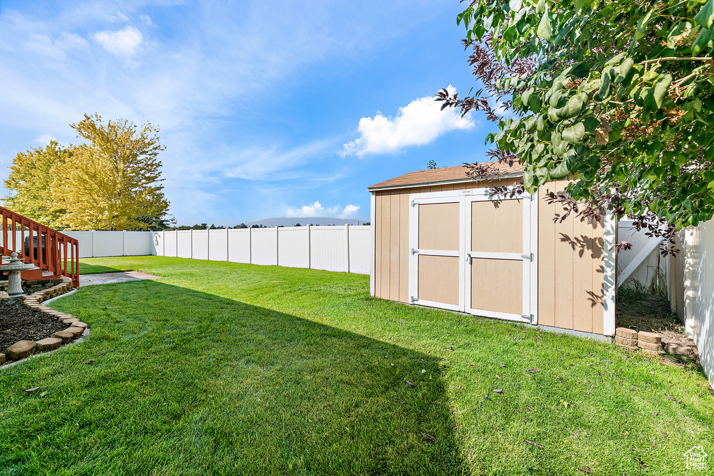 View of yard with a storage shed