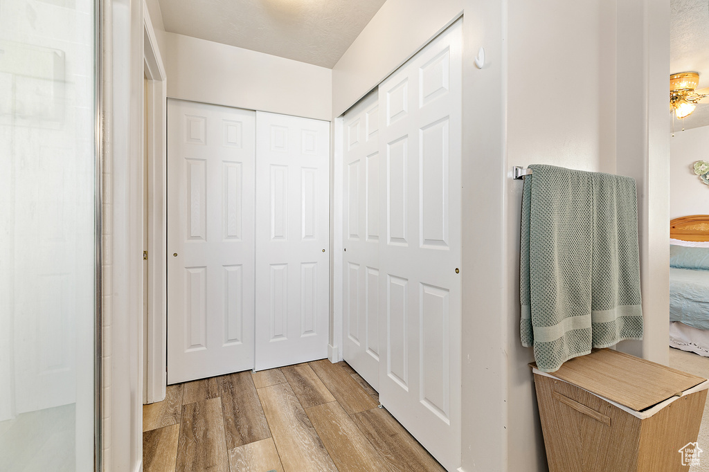 Hallway with light hardwood / wood-style floors