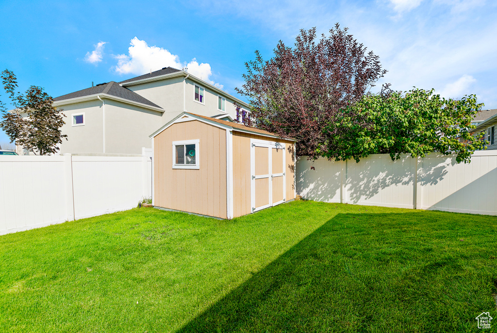 View of yard with a storage unit