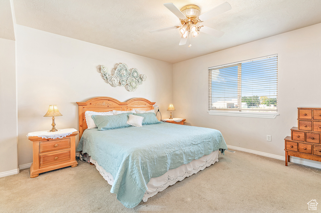 Carpeted bedroom with ceiling fan