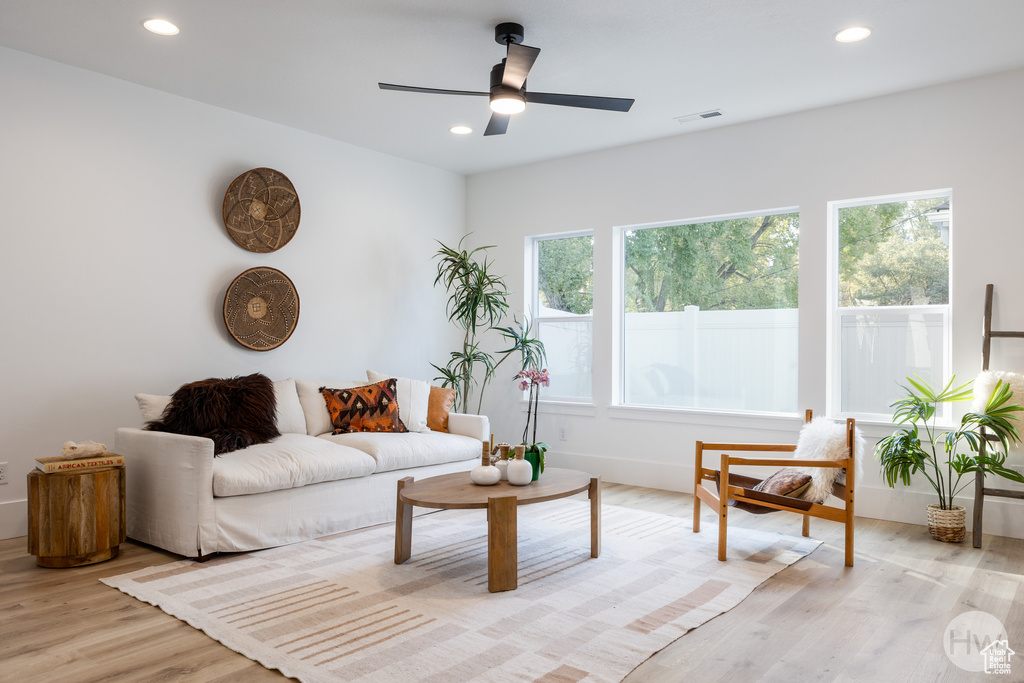 Living room featuring ceiling fan and light hardwood / wood-style floors