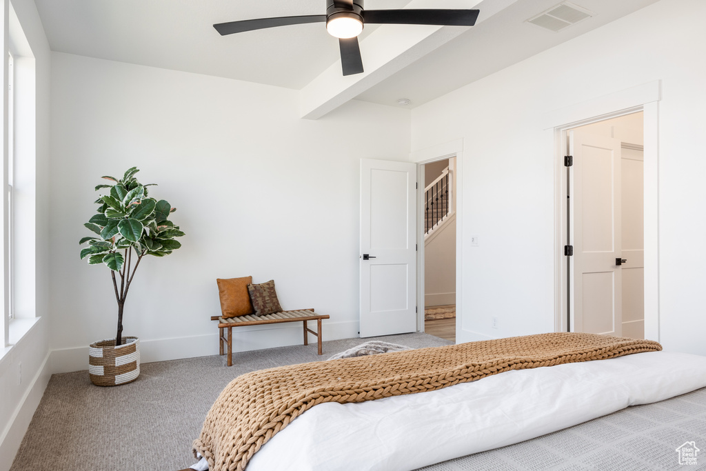 Carpeted bedroom featuring ceiling fan