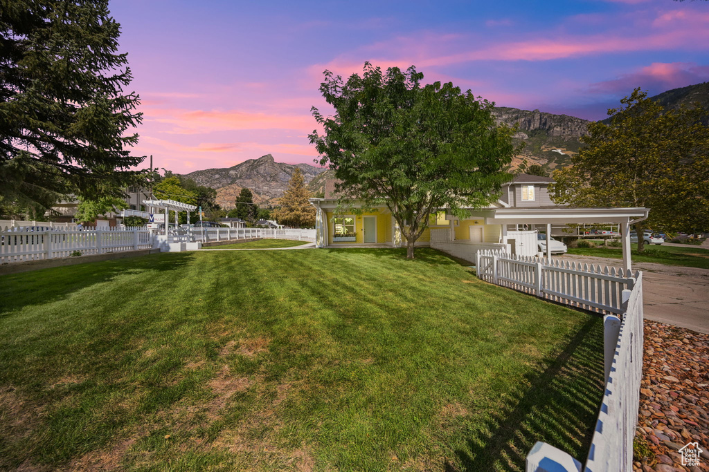 Yard at dusk featuring a mountain view