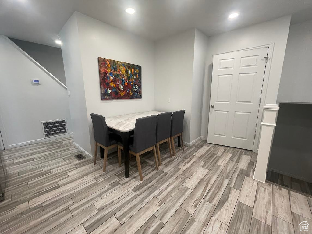 Dining space with light hardwood / wood-style floors