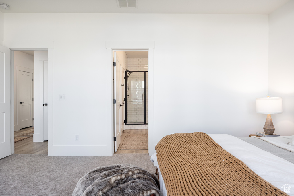 Bedroom featuring light colored carpet