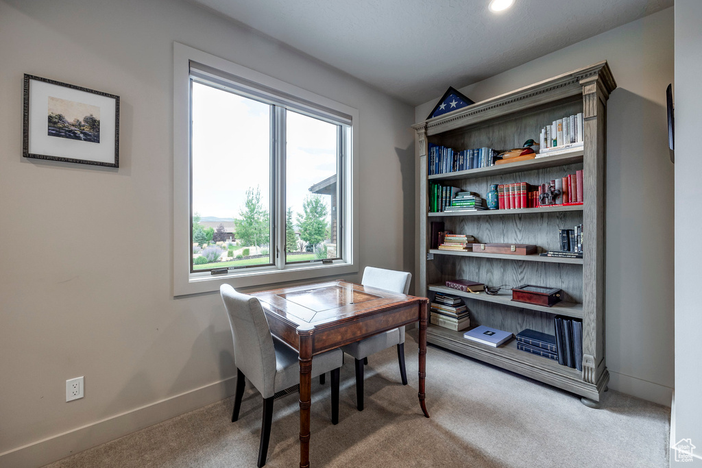 Carpeted office space featuring baseboards