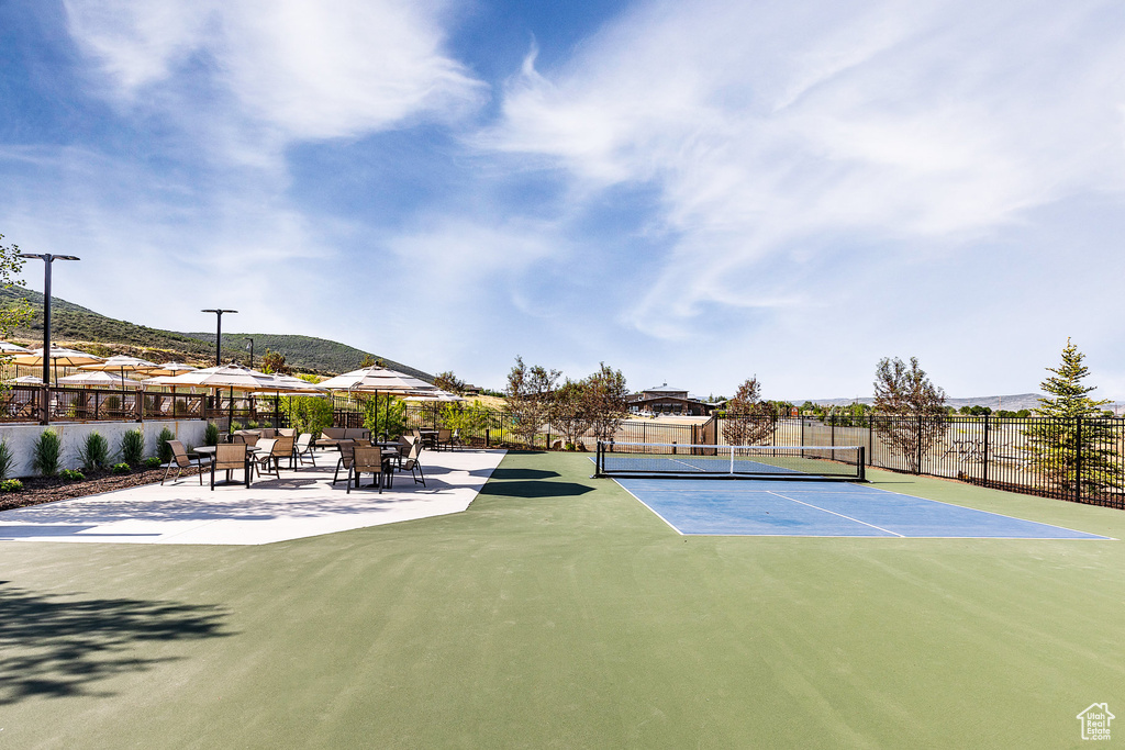View of tennis court featuring a mountain view