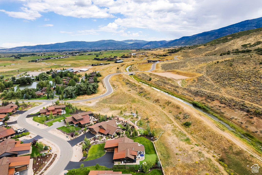 Aerial view of property and surrounding area with a mountainous background