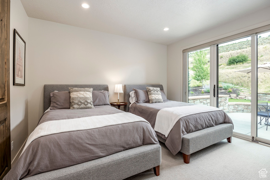 Bedroom featuring access to exterior, recessed lighting, and light colored carpet