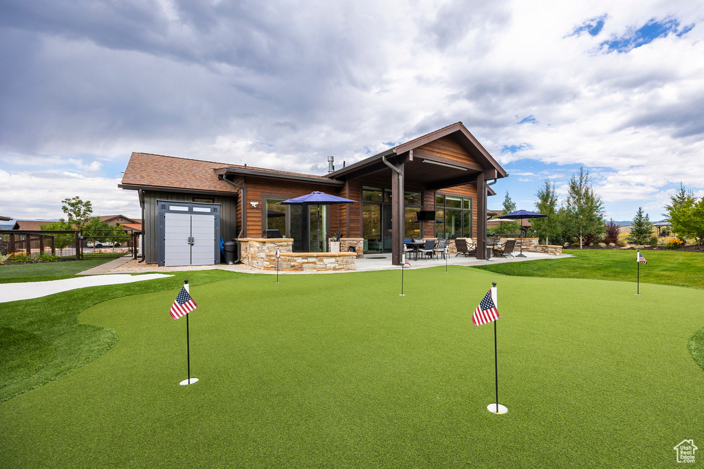 Surrounding community with a putting area, a patio area, and a garage