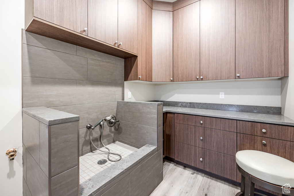 Full bath with wood finished floors
