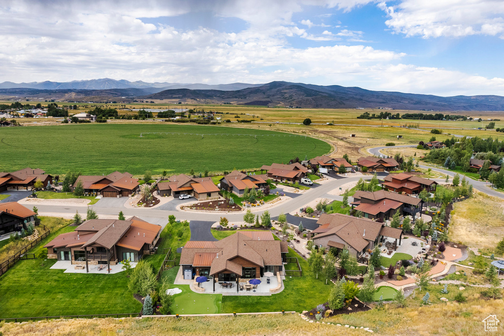 Aerial view of property's location featuring a mountain backdrop and nearby suburban area