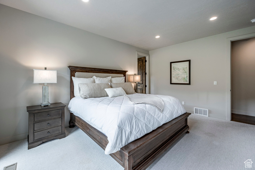 Carpeted bedroom with recessed lighting and baseboards