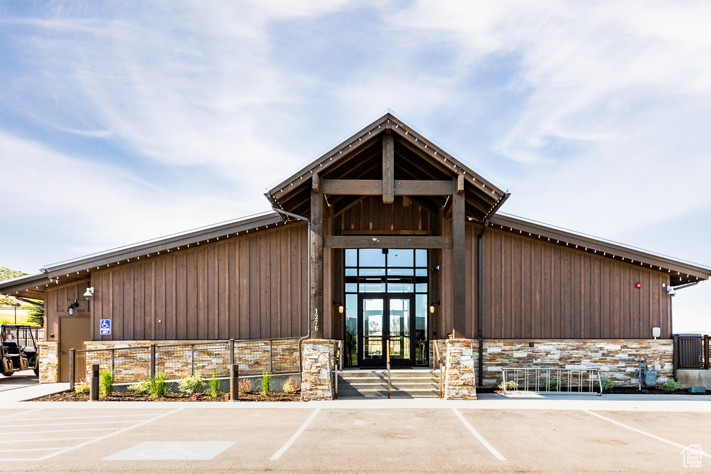 View of building exterior with uncovered parking