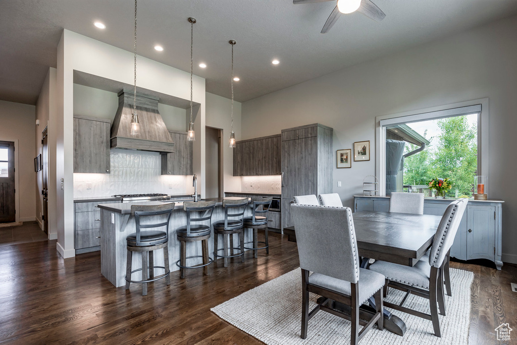 Dining room with healthy amount of natural light, dark wood-type flooring, recessed lighting, a ceiling fan, and baseboards