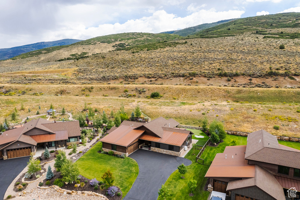 Aerial view of property and surrounding area featuring mountains