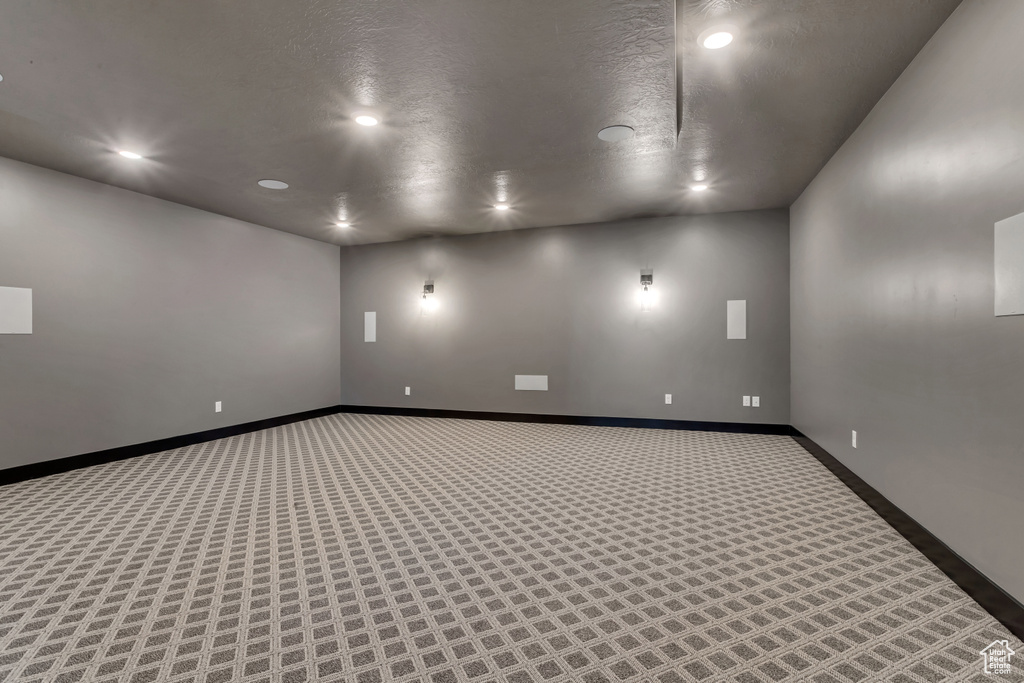 Carpeted spare room featuring a textured ceiling