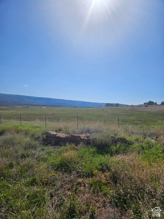 View of landscape featuring a mountain view and a rural view