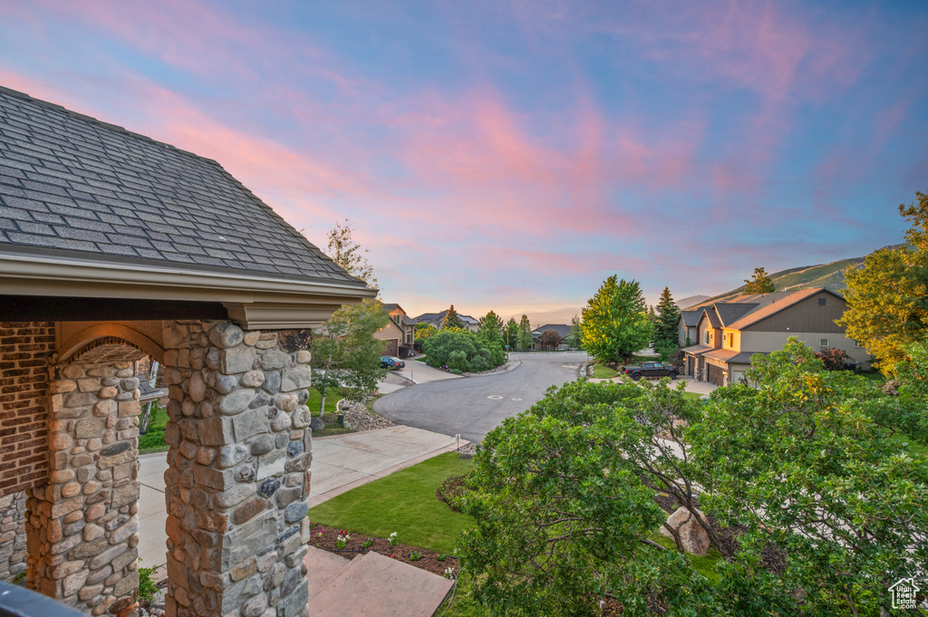 Yard at dusk featuring a residential view