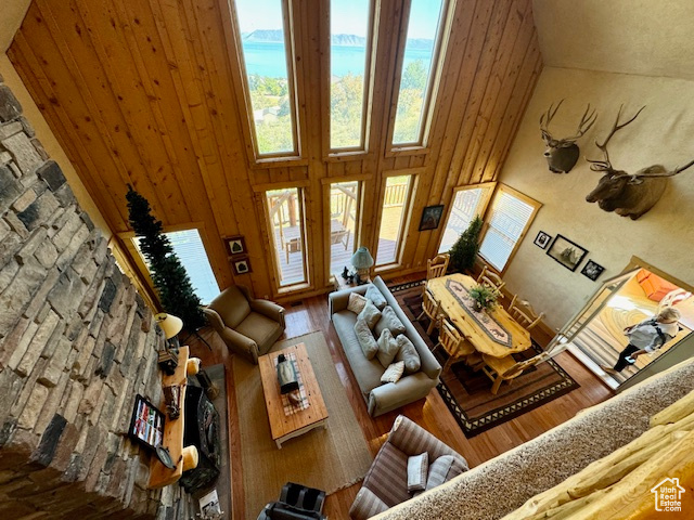 Unfurnished living room with a towering ceiling and hardwood / wood-style flooring