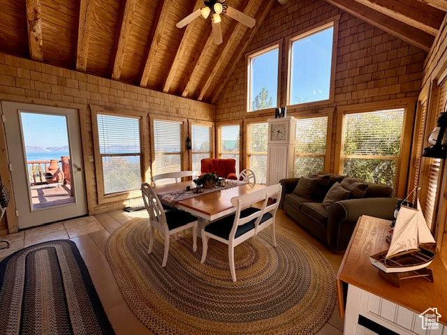 Interior space featuring wooden ceiling, lofted ceiling with beams, and ceiling fan