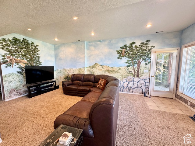 Living room with a textured ceiling and light colored carpet