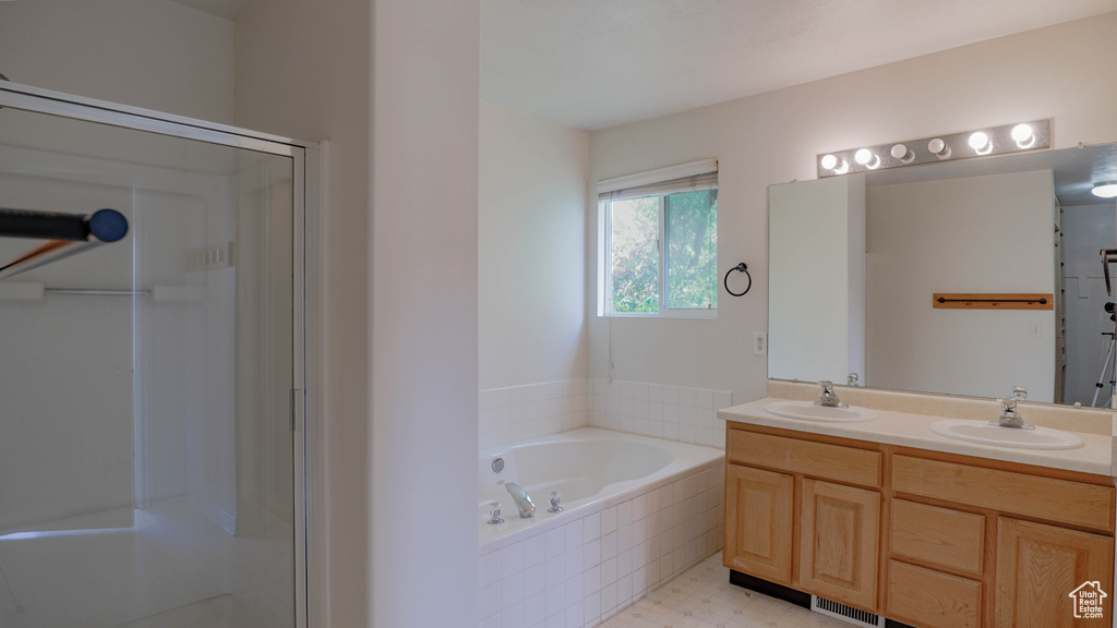 Bathroom with vanity and shower with separate bathtub