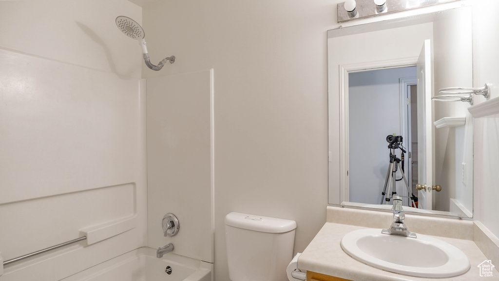 Full bathroom with toilet, shower / washtub combination, and vanity