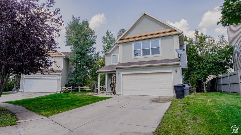 Front of property with a front yard and a garage