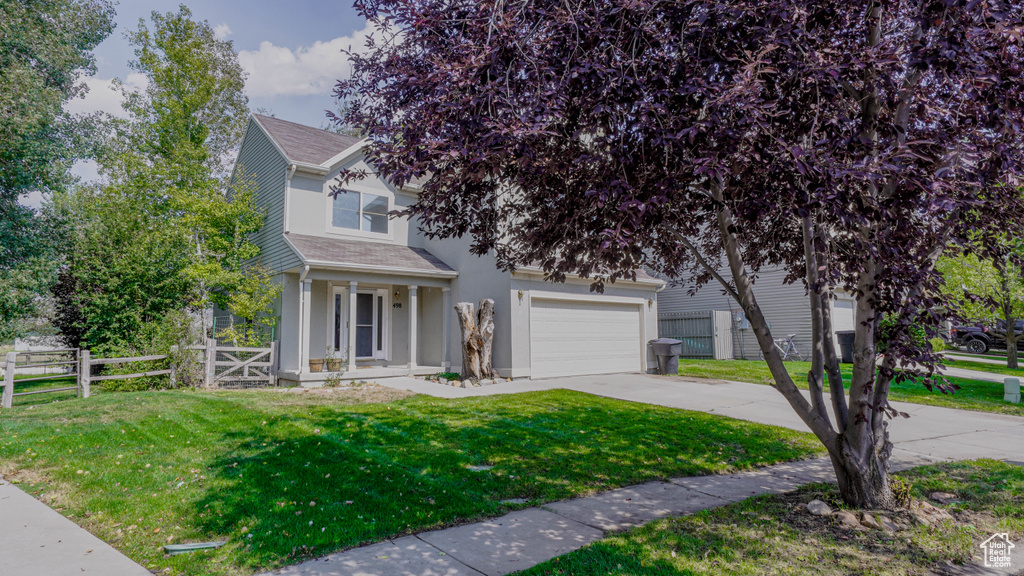 Obstructed view of property featuring a front lawn