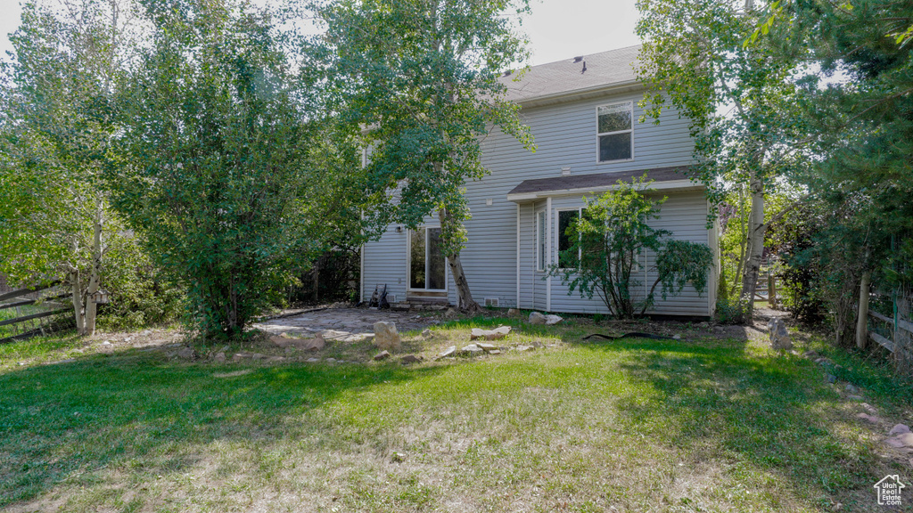 Back of property featuring a lawn