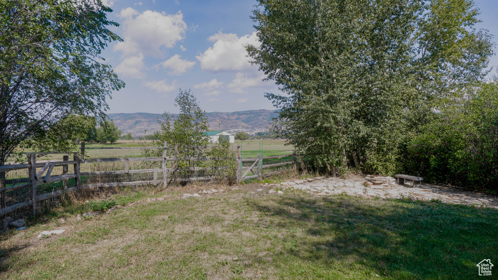 View of yard with a mountain view and a rural view