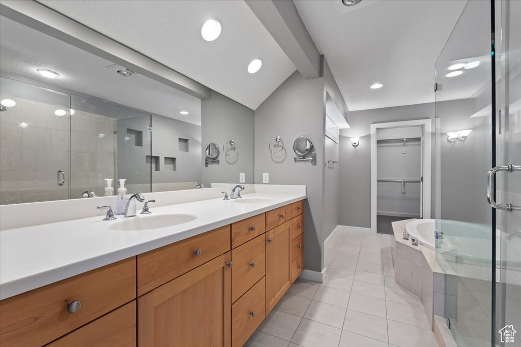 Full bathroom with double vanity, a sink, a shower stall, baseboards, and tile patterned floors