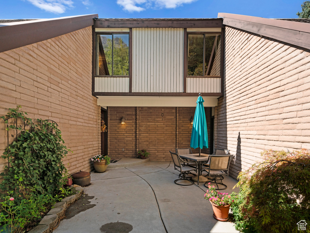 Back of property with a patio and a balcony