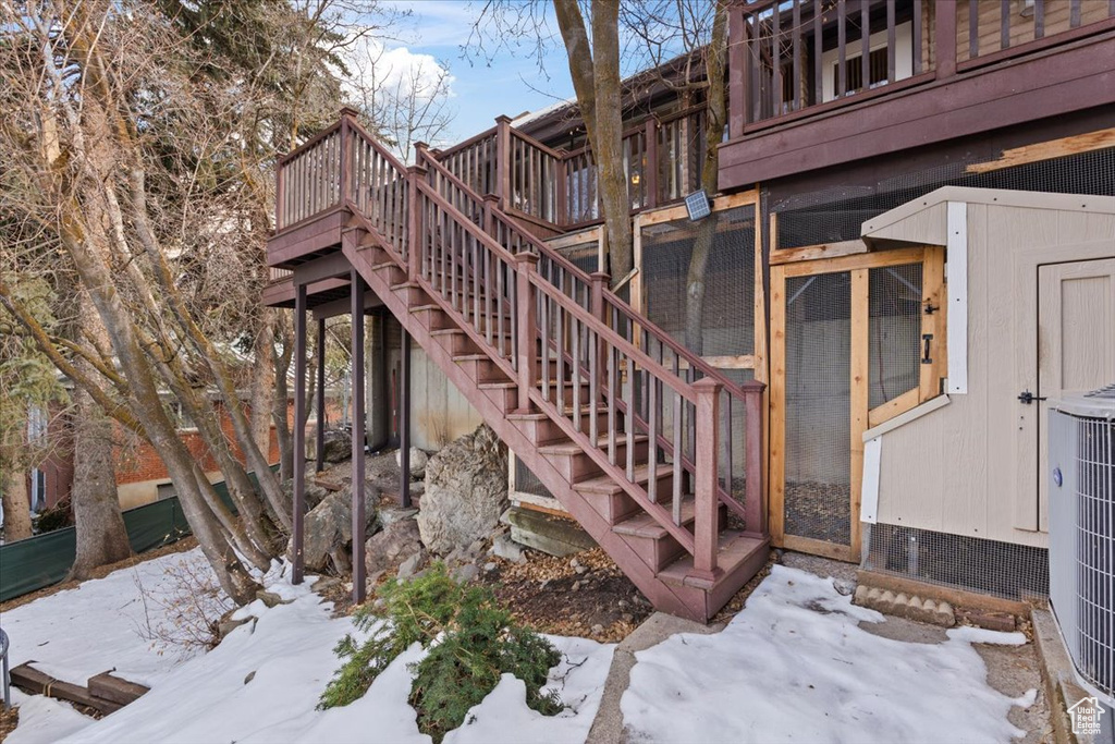 Exterior space with cooling unit, an outdoor structure, and stairs