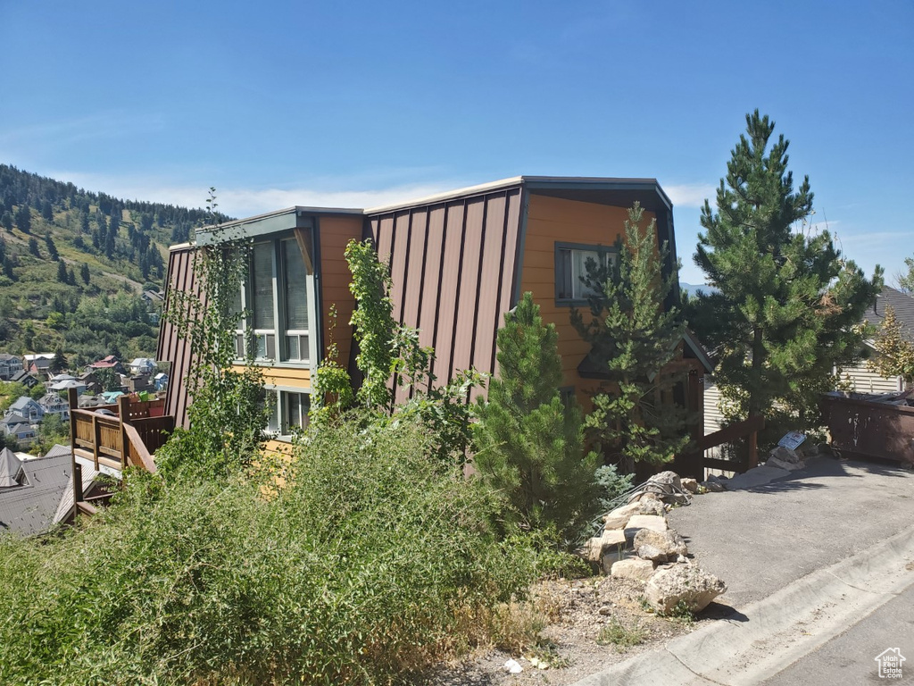 View of side of home featuring a mountain view