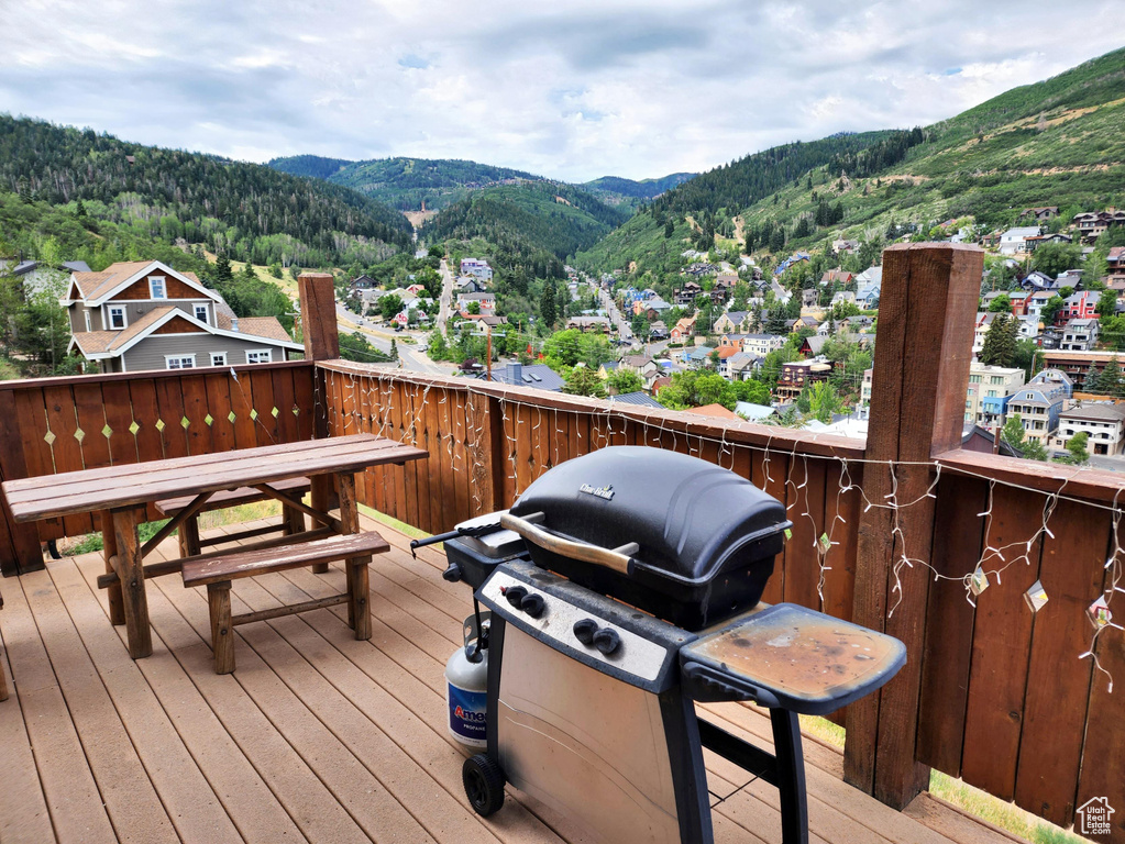 Wooden deck featuring a mountain view and grilling area