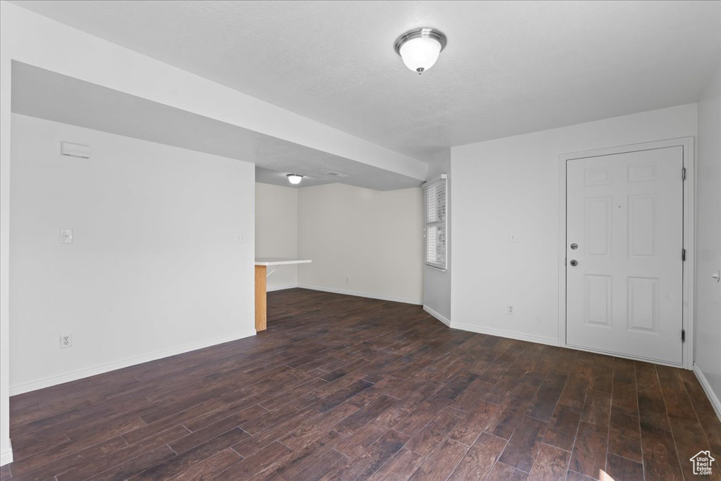 Unfurnished room featuring dark wood-type flooring